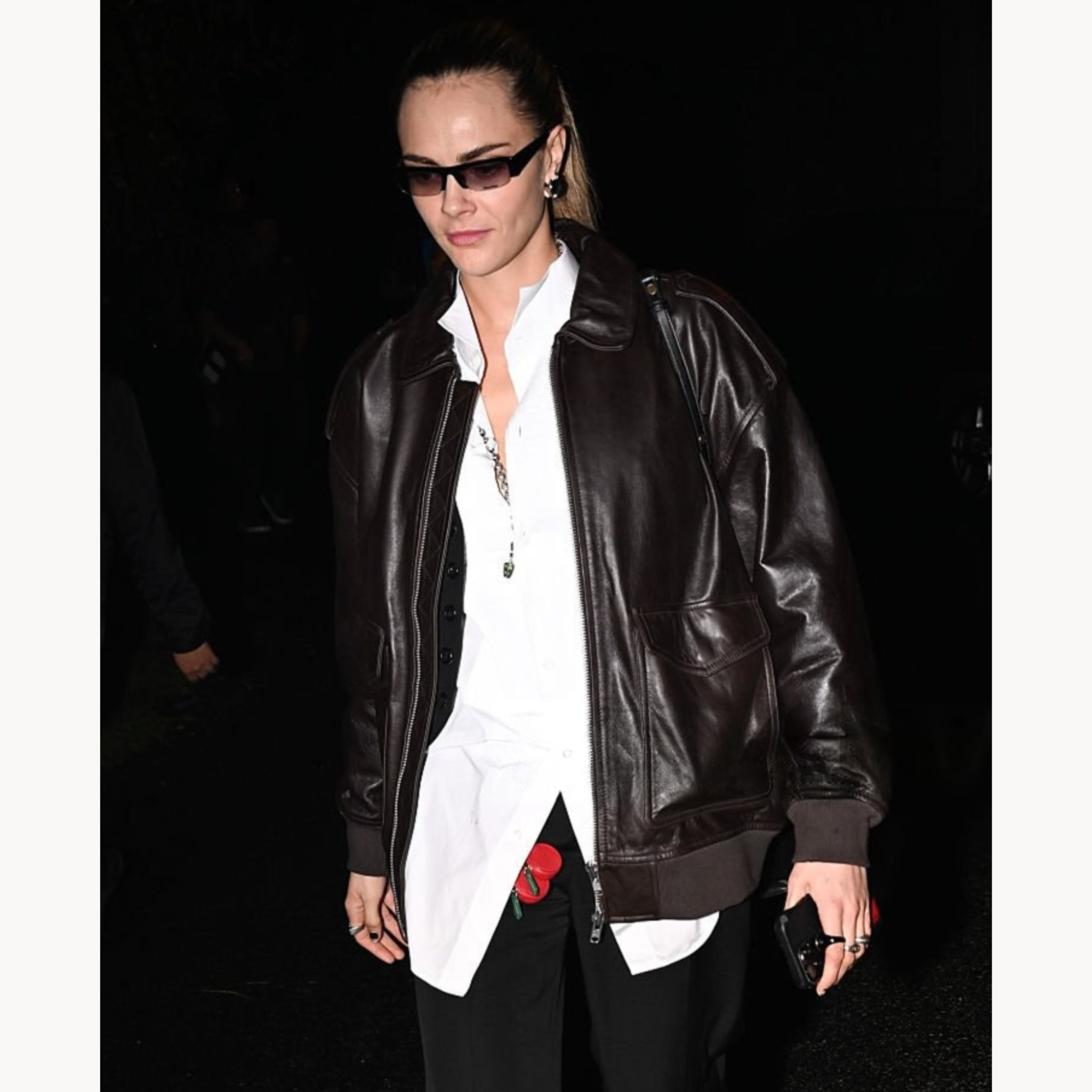 Cara Delevingne wearing oversized brown leather bomber jacket with patch pockets in Los Angeles 2025