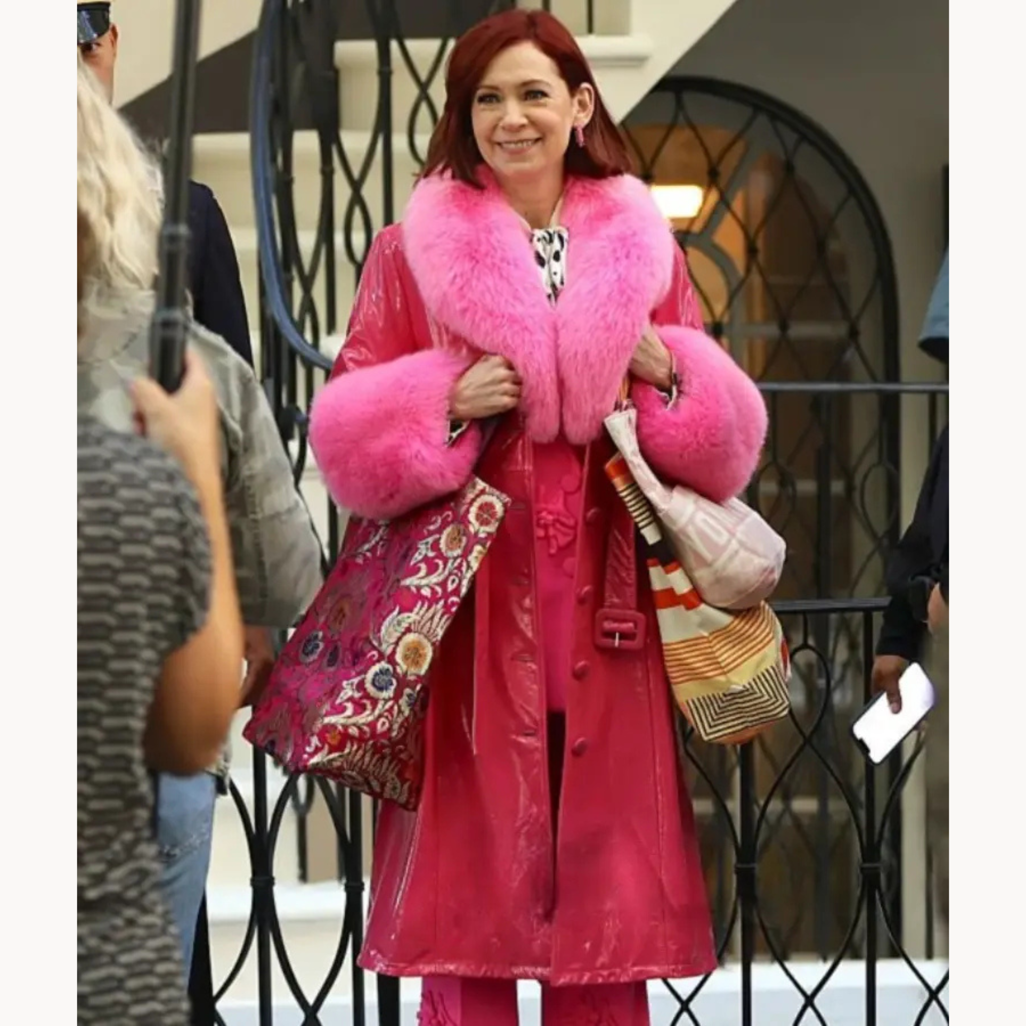 Carrie Preston wearing hot pink faux fur trimmed long leather coat with oversized lapel collar and matching belt in Elsbeth Season 3