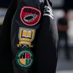 Celebrity-inspired KhaDarel Hodge black varsity jacket featuring red and gold details