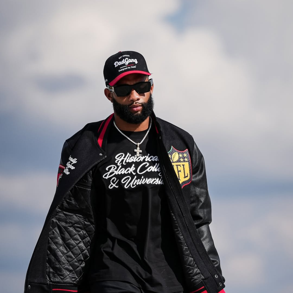 KhaDarel Hodge wearing black varsity letterman jacket with red and gold patches from NFL x HBCU