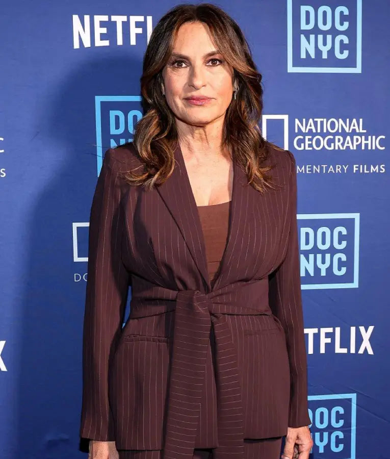 Mariska Hargitay wearing a pinstripe burgundy wrap belted coat at the 2025 DOC NYC Visionaries Lunch