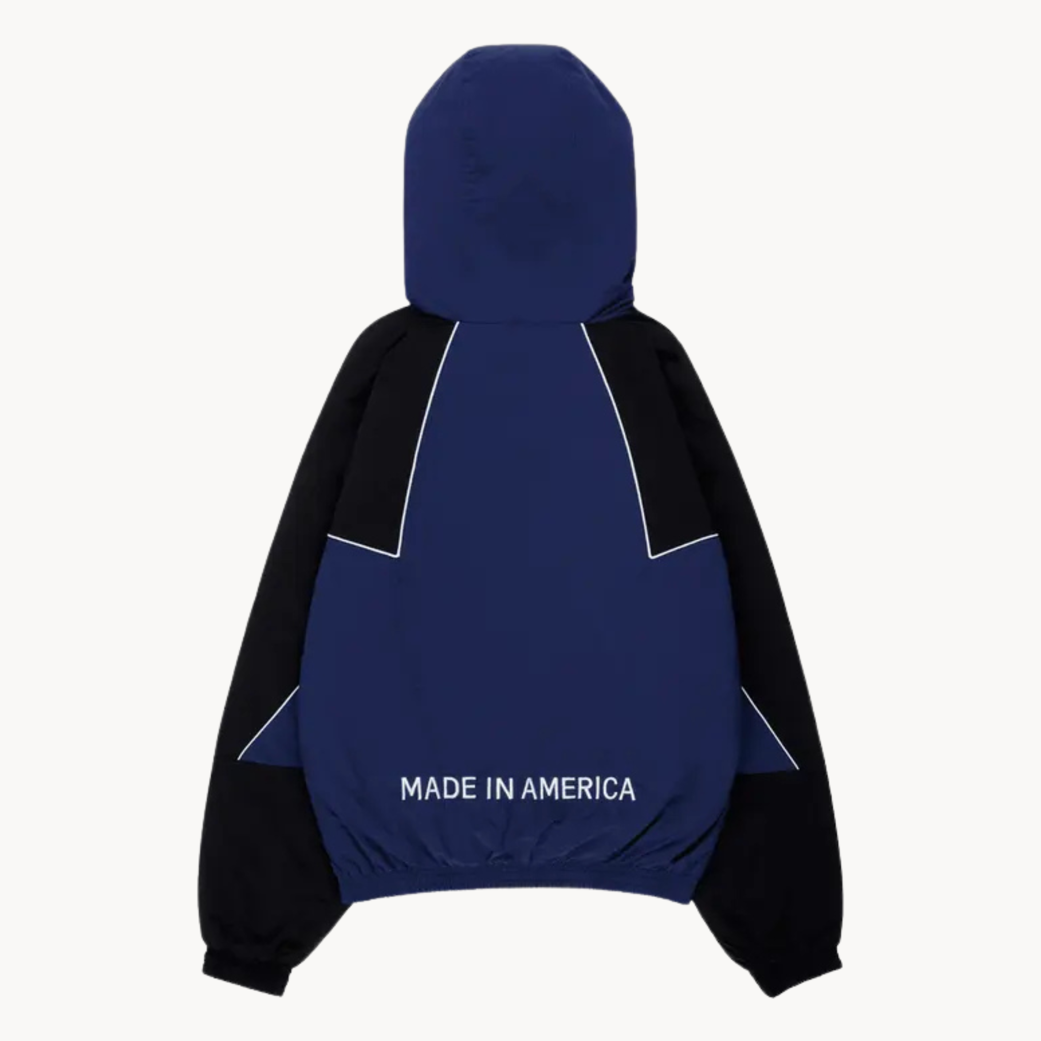 Marty Supreme full-zip track jacket featuring orange star chest print and white piping, available in blue.