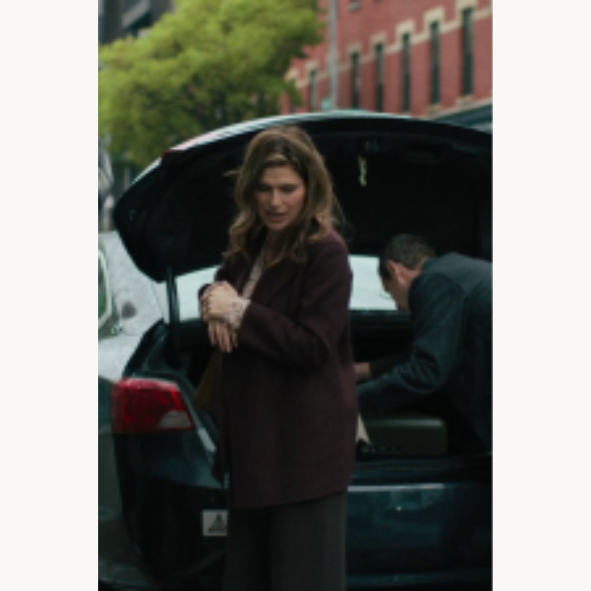 Lake Bell wearing a burgundy notch lapel coat as Barb Trosper in The Chair Company S01E05